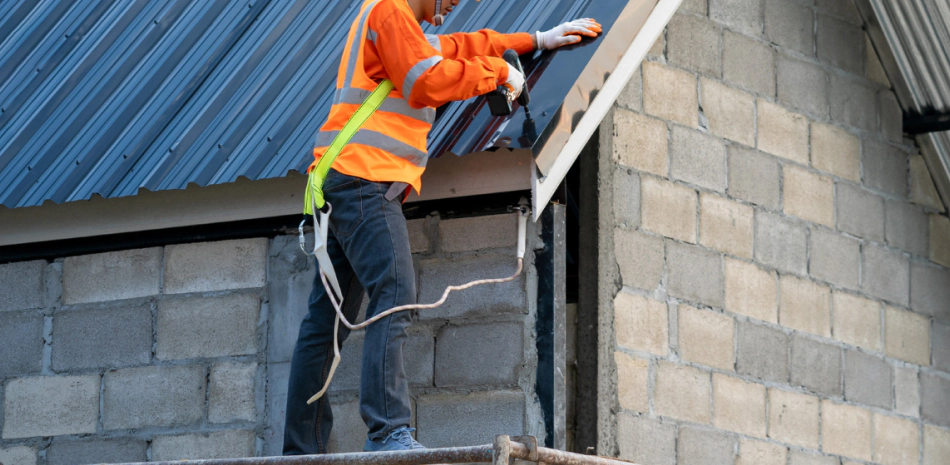 man working on metal roofing