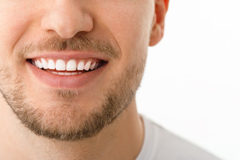 The closeup view of a man's smile.