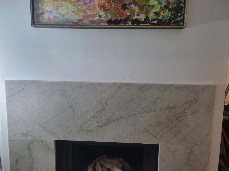 A fireplace with a marble surround.