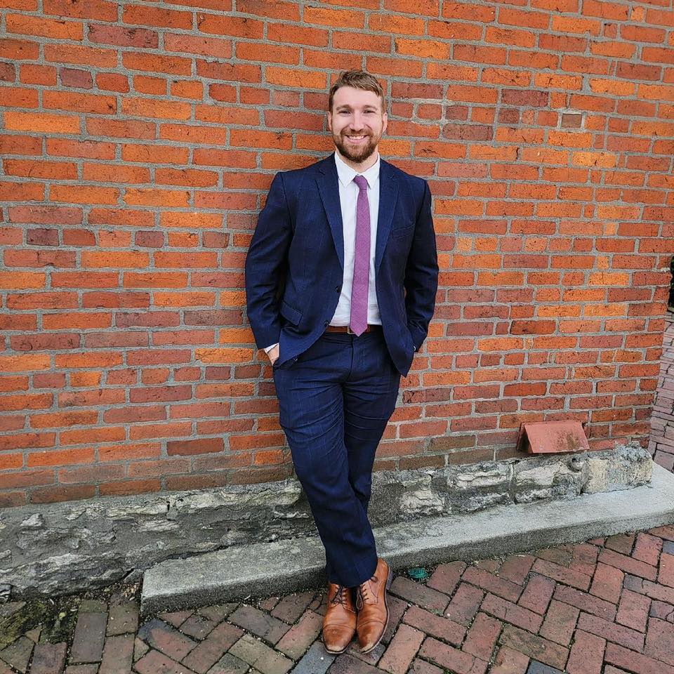 Attorney Seth R. Smith stands in front of a brick wall