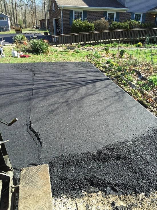 A section of asphalt needing repairs.