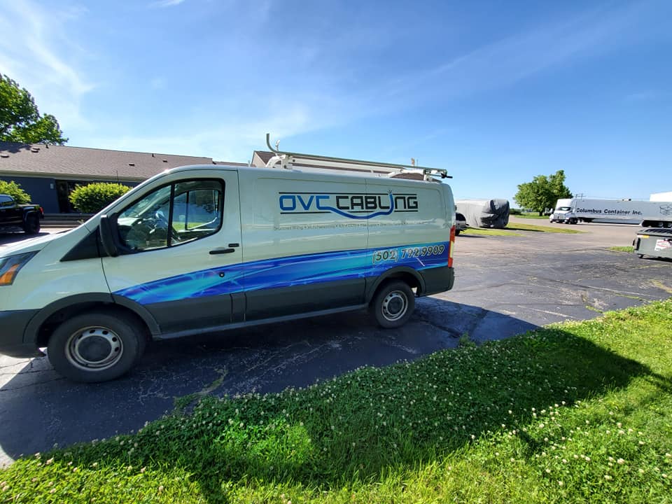 OVC Cabling van sitting in a parking lot.