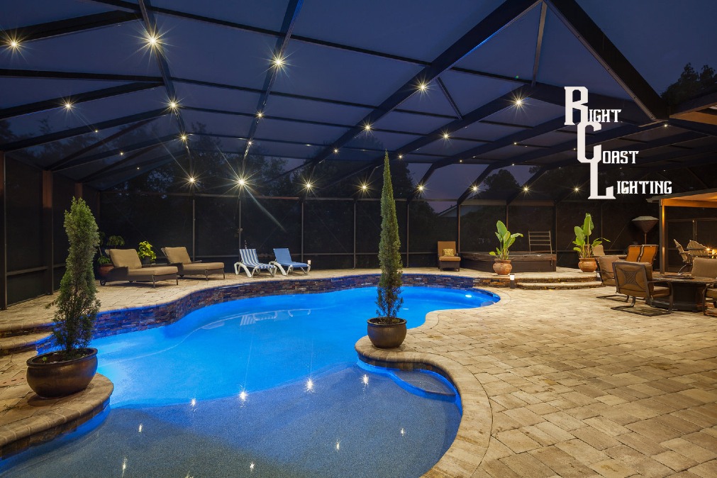 Pool enclosure illuminated by a screen enclosure lighting system.