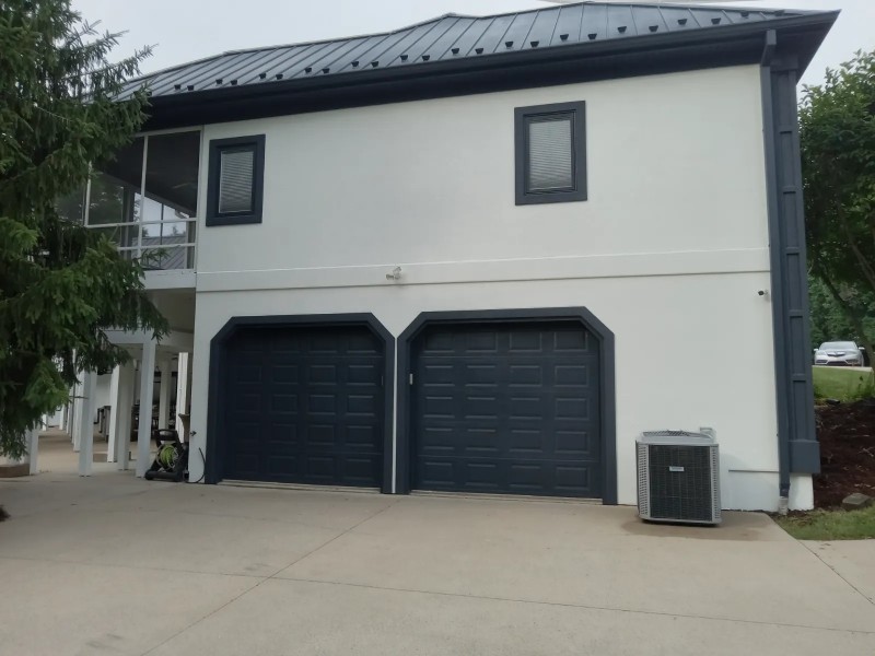 An exterior paint job on a two-car garage.