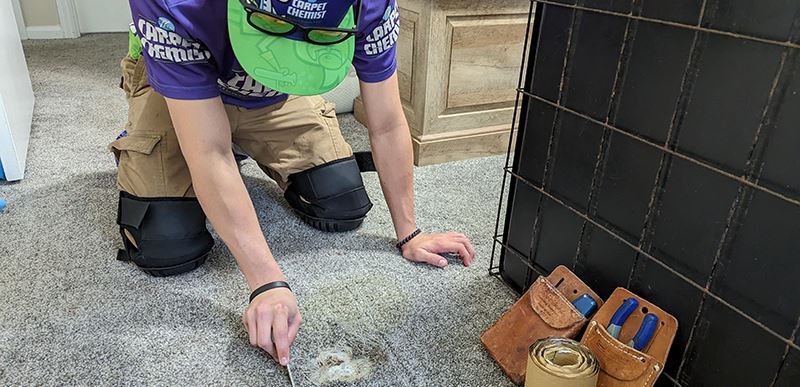 Employee repairing a hole in the carpet