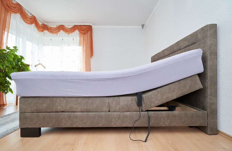 An adjustable bed with the top raised.