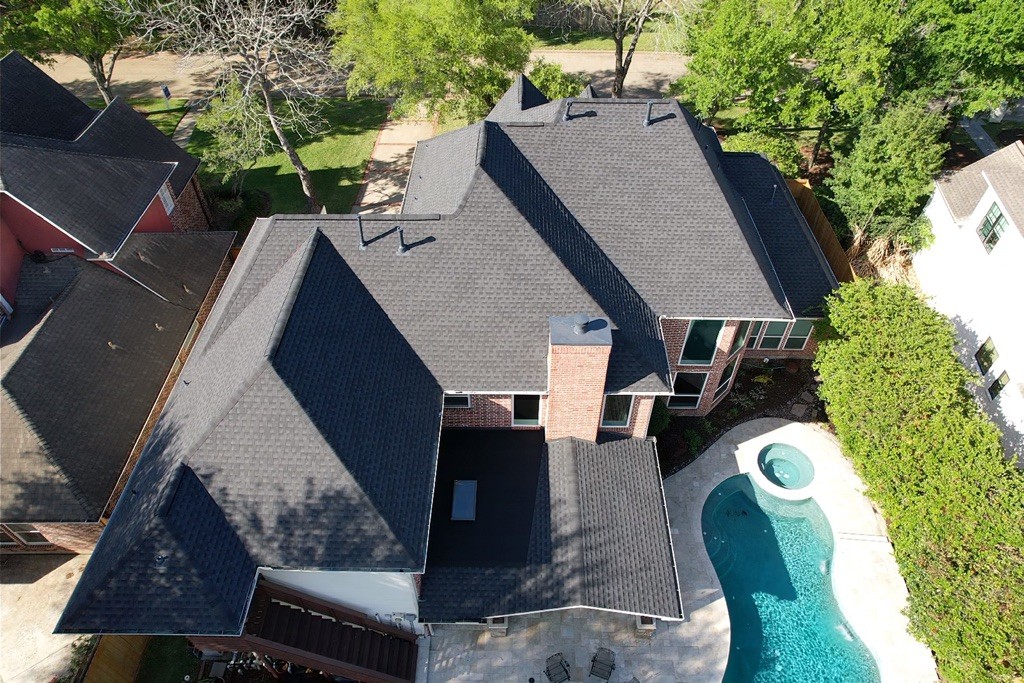 An overhead view of a home with a grey shingle roof.