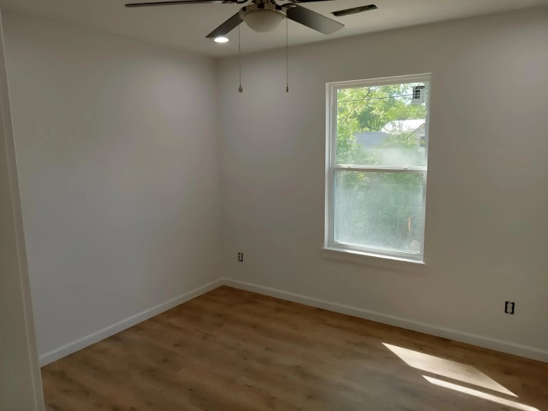 A small bedroom with a fresh paint job.