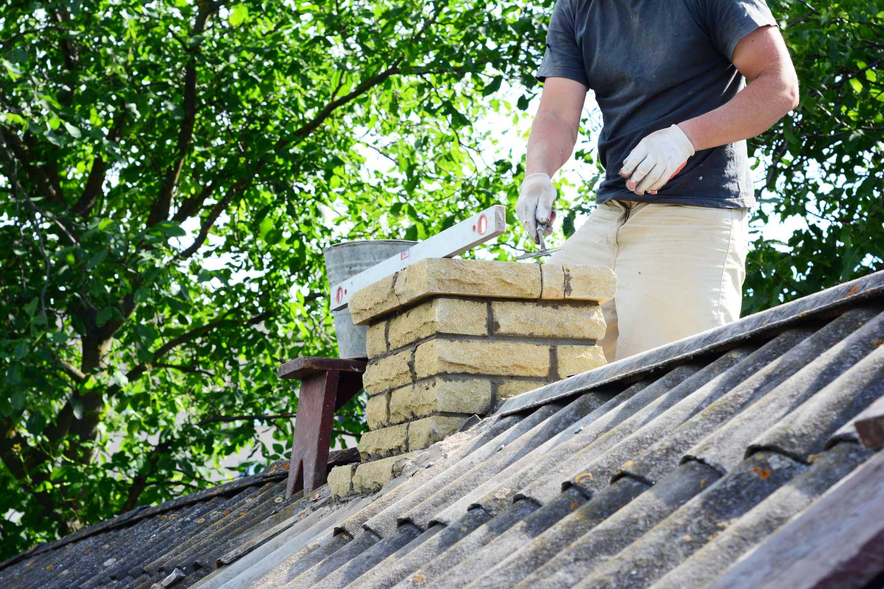 Crewman cleaning and maintaining a residential chimney