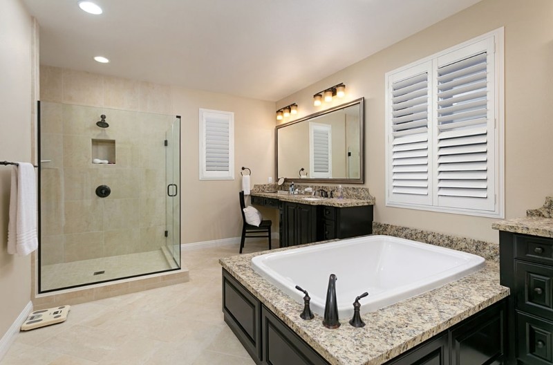 New master bath with tile floor, large soaking tub, twin vanities with granite tops