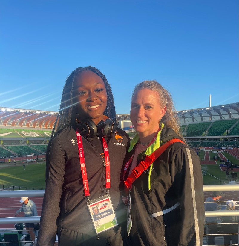 Christa Duncan posing with one of her track and field athletes.