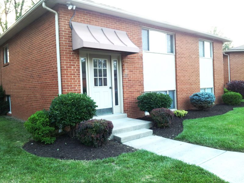 The front entrance door to an apartment with concrete steps.