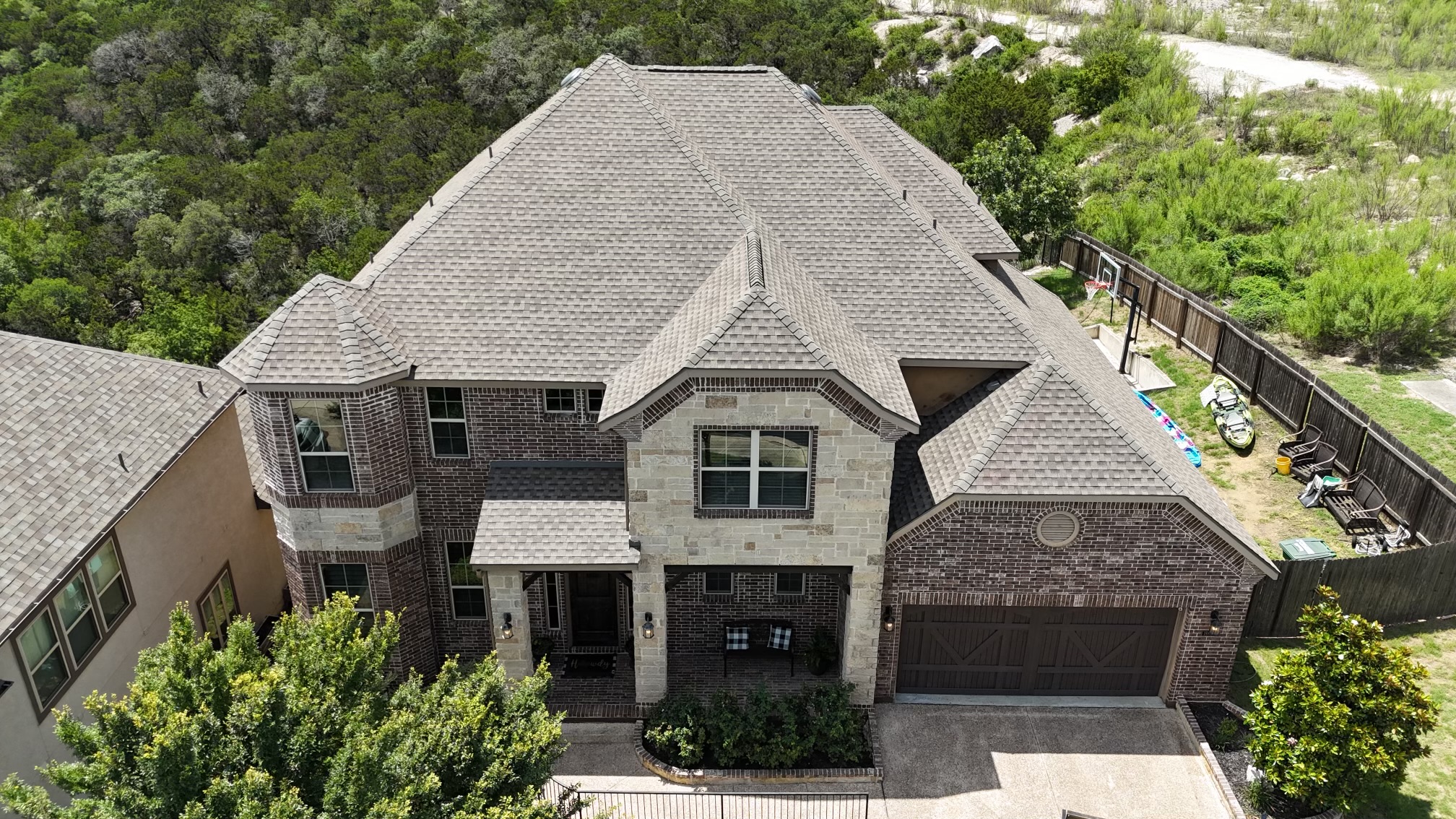 A large home with a gray shingled roof.