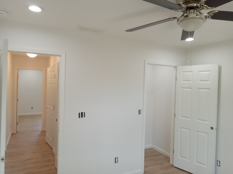 An open living area of a home with a white paint job.