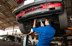 Mechanic working on a red car