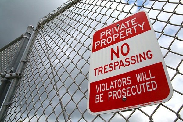 Chain link fence with a sign reading, 