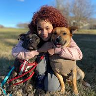 Toni Jackson posing with two dogs.