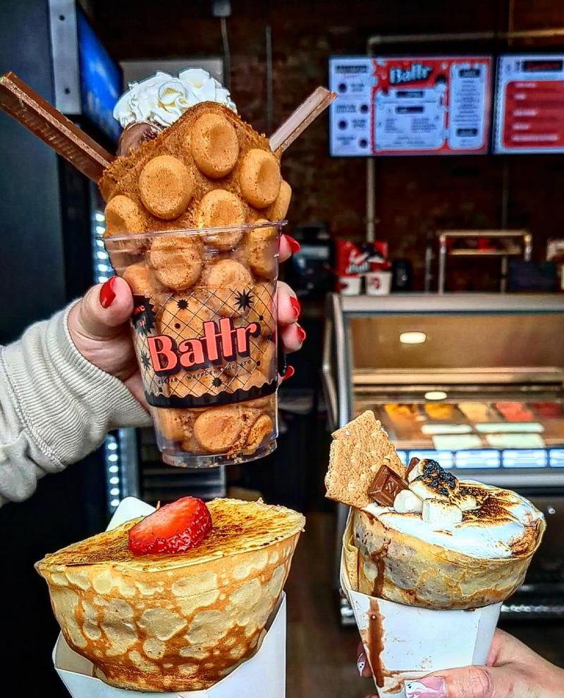 A bubble waffle ice cream cone with text that reads 