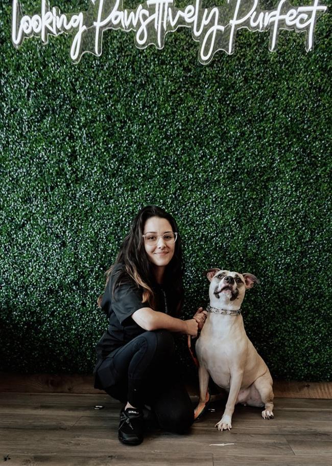 Kylie posing with a dog