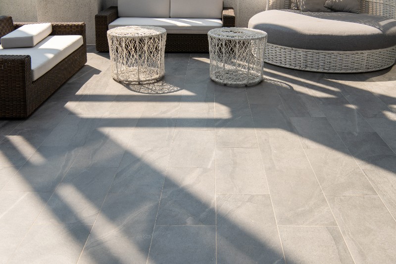 Concrete patio stamped to look like stone tile.