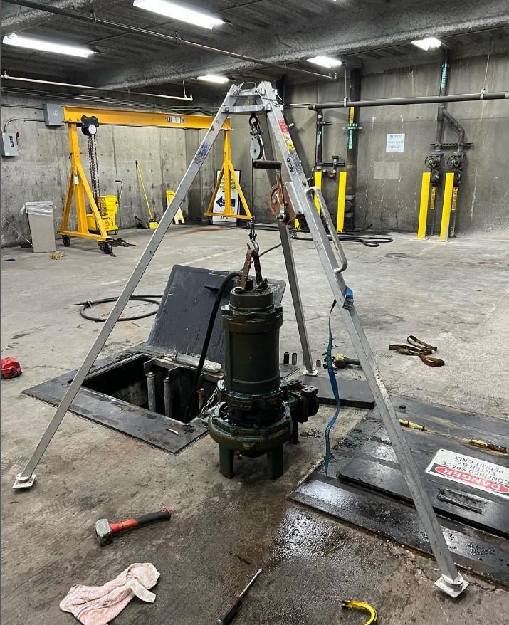 Equipment sits next to a hole over a septic system.