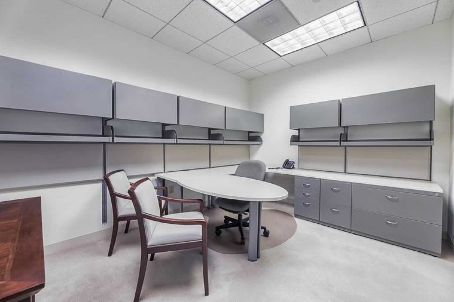 An office space with conference tables and storage cabinets.