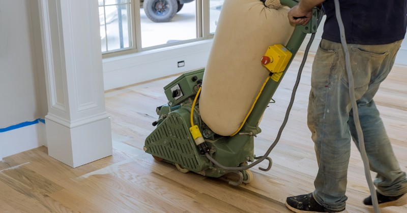 floor refinishing machine being used on a hardwood floor