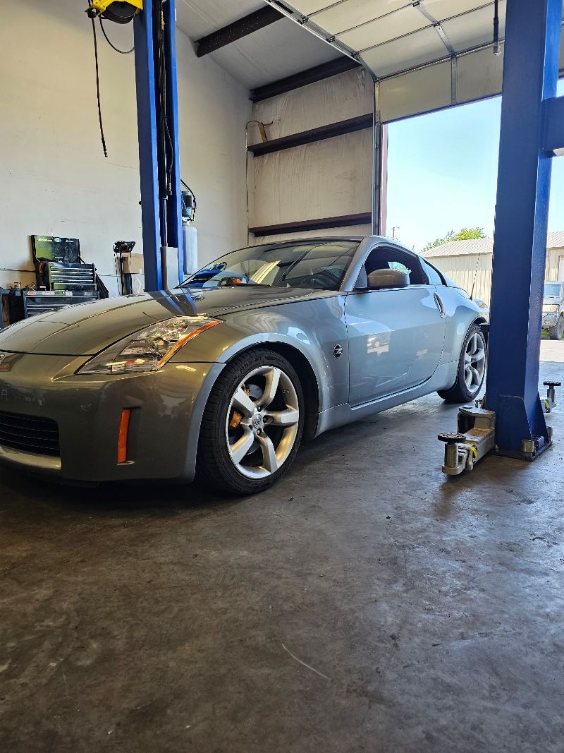 Nissan Z parked in an auto service bay