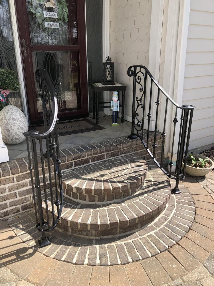 Front entrance with fancy iron railing.