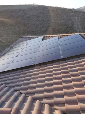 Solar panels on a clay tile roof.
