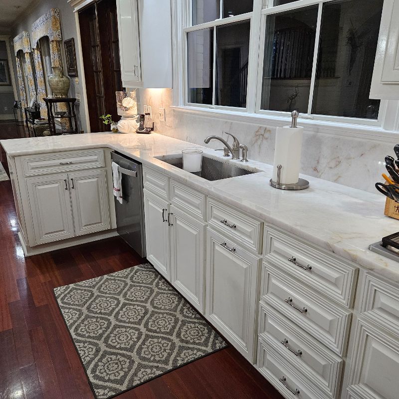 A kitchen with marble countertops.