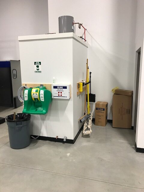 Warehouse equipment sits in a corner.
