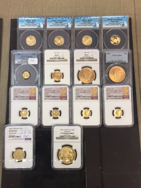 A display of gold coins in individual sleeves