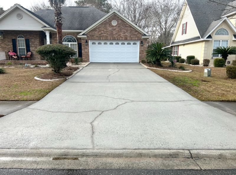 The view of the same driveway following a pressure washing.