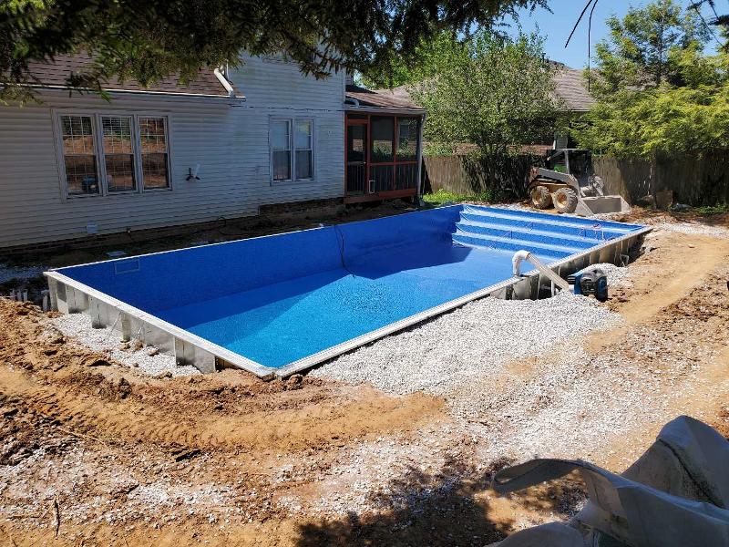 An overhead view of a backyard swimming pool during construction