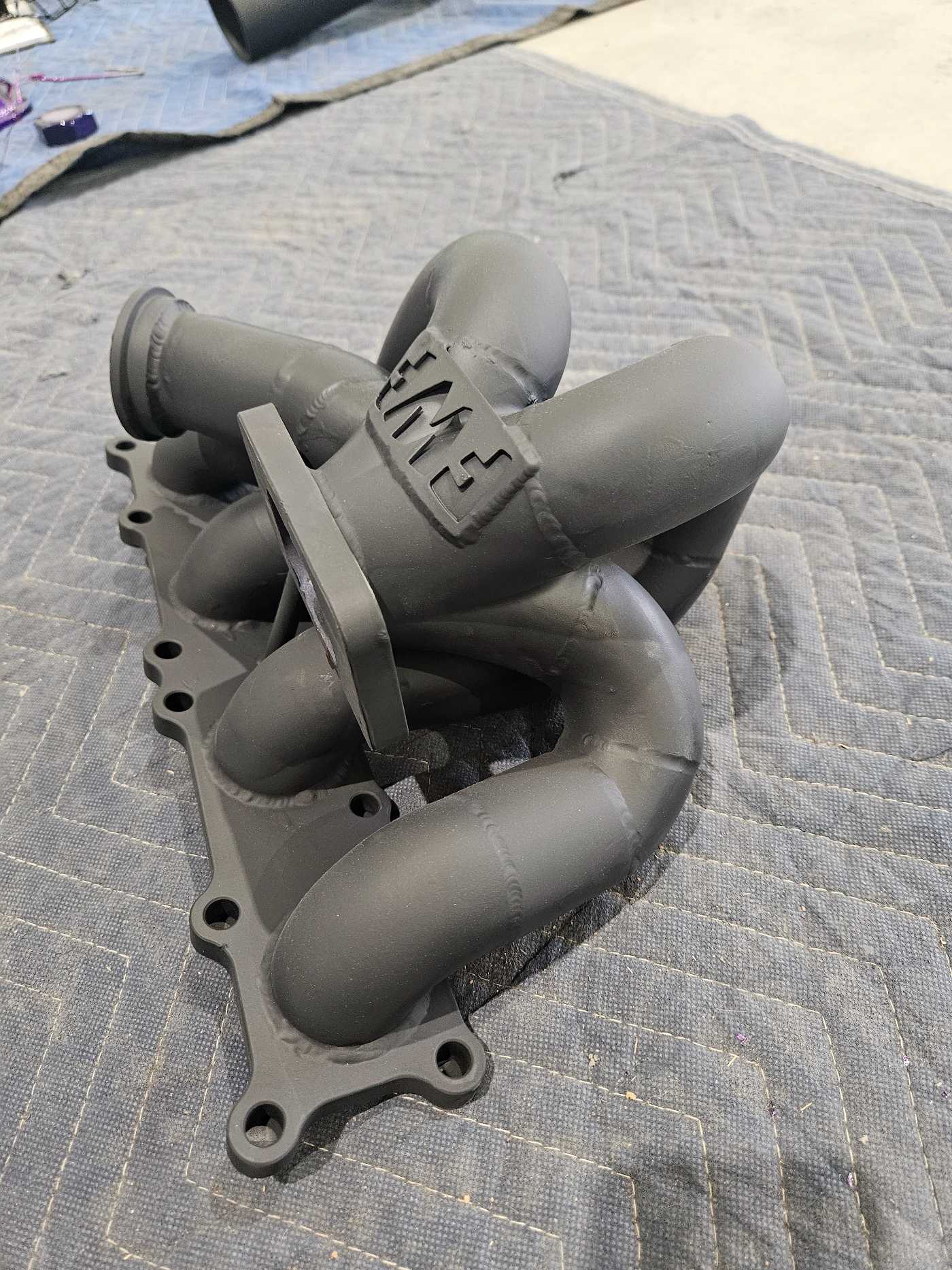 Iron auto engine parts lie on a blanket following coating.