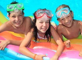 Three children in a swimming pool