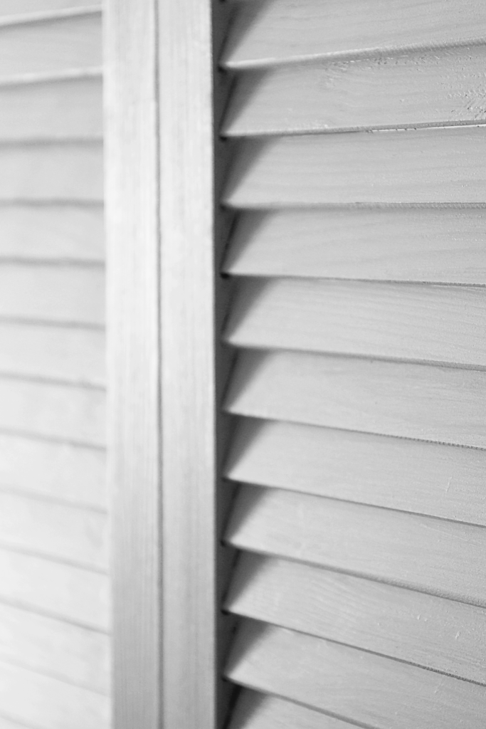 A close up image of newly installed white siding. 