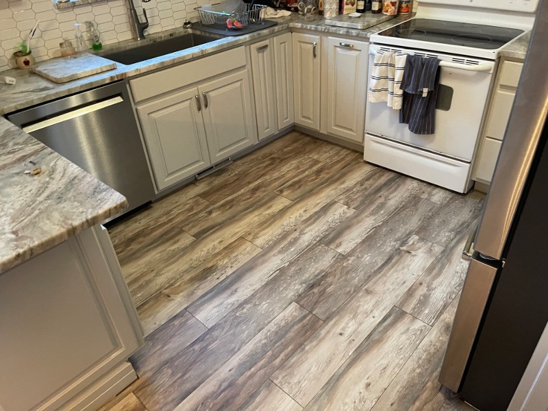 Luxury vinyl flooring is seen in a kitchen.