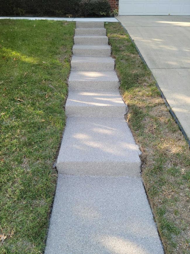 An outdoor sidewalk steps with an epoxy coating.