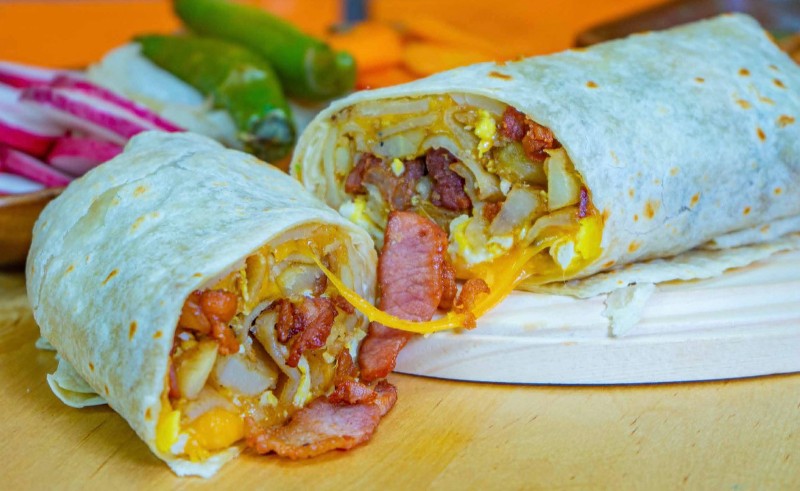 Breakfast burrito cut in half.