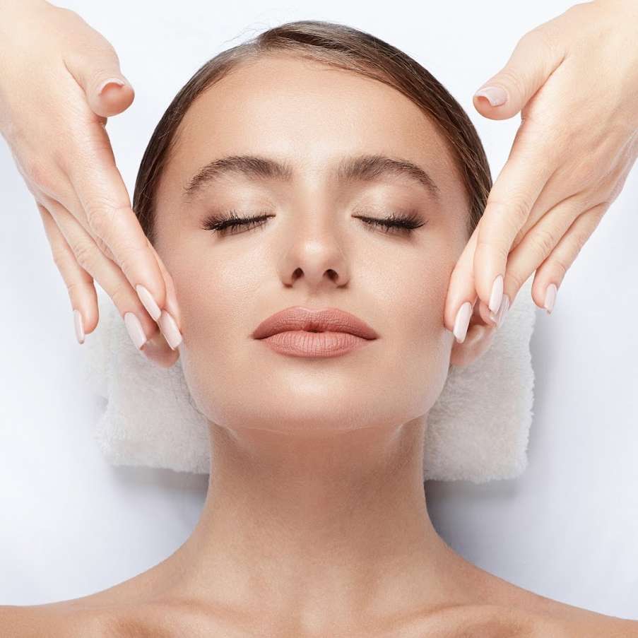 Woman closes her eyes as she gets a custom facial treatment.