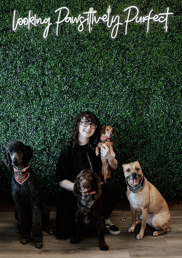 Sam posing with four dogs