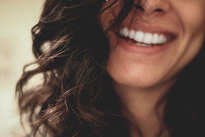 A young girl smiles.