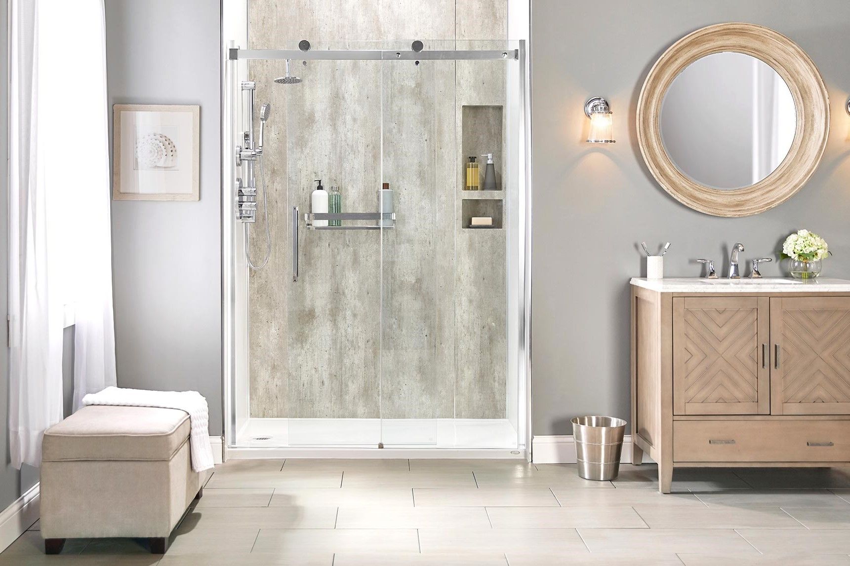 A tiled walk-in shower with glass sliding doors next to a single-sink vanity with two doors and one drawer below a round mirror.
