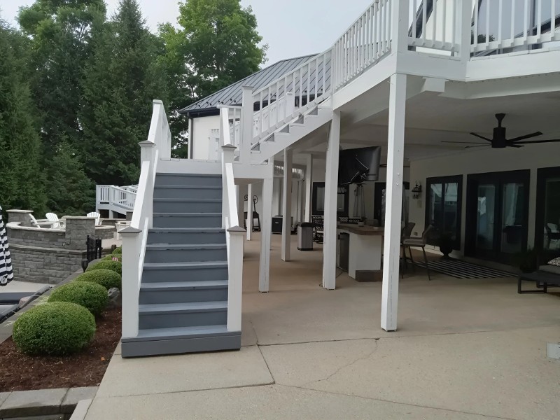 A freshly painted outdoor deck with a stairway.