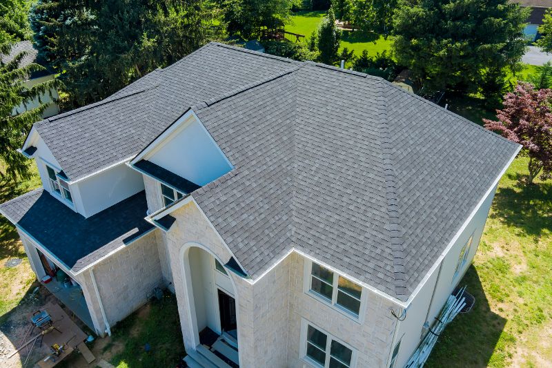 Cute white house with gray asphalt shingles.