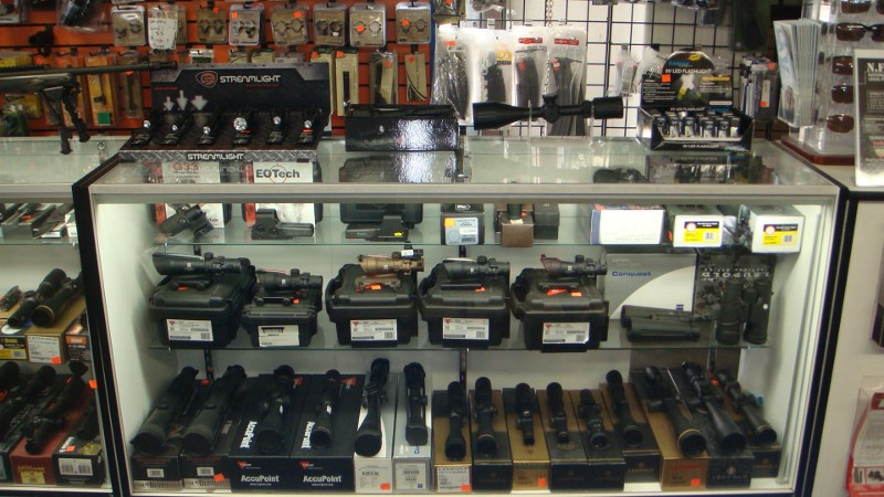 A display case of scopes and firearms accessories.