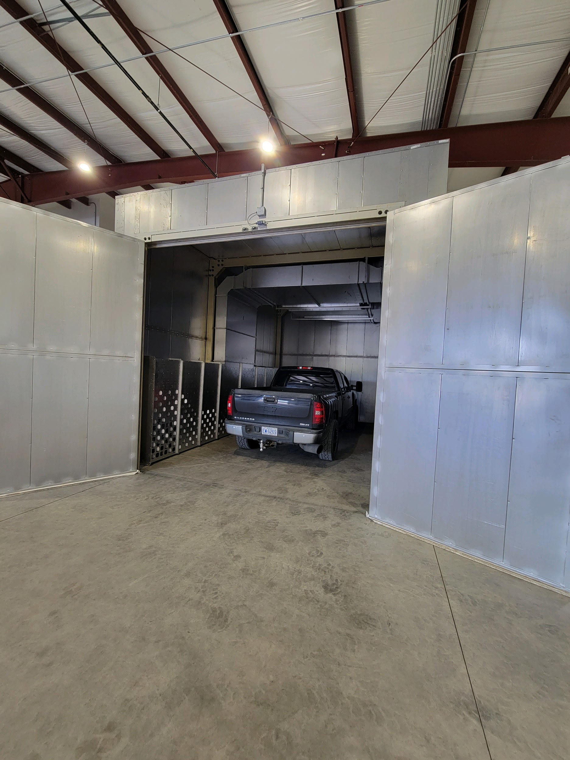 A pickup truck enters the large oven area for heat coating.