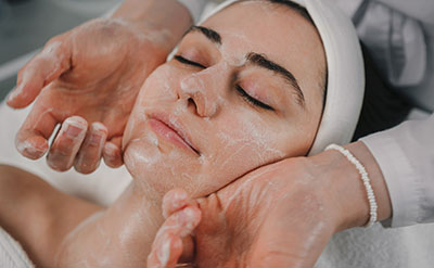 woman getting facial foam massage spa